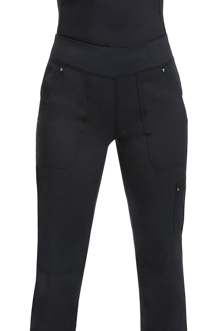 A young woman wearing a pair of Purple Label Women's Tori Yoga Waistband Scrub Pants in Black featuring a fabric made of  77% Polyester/ 20% Rayon/ 3% Spandex.