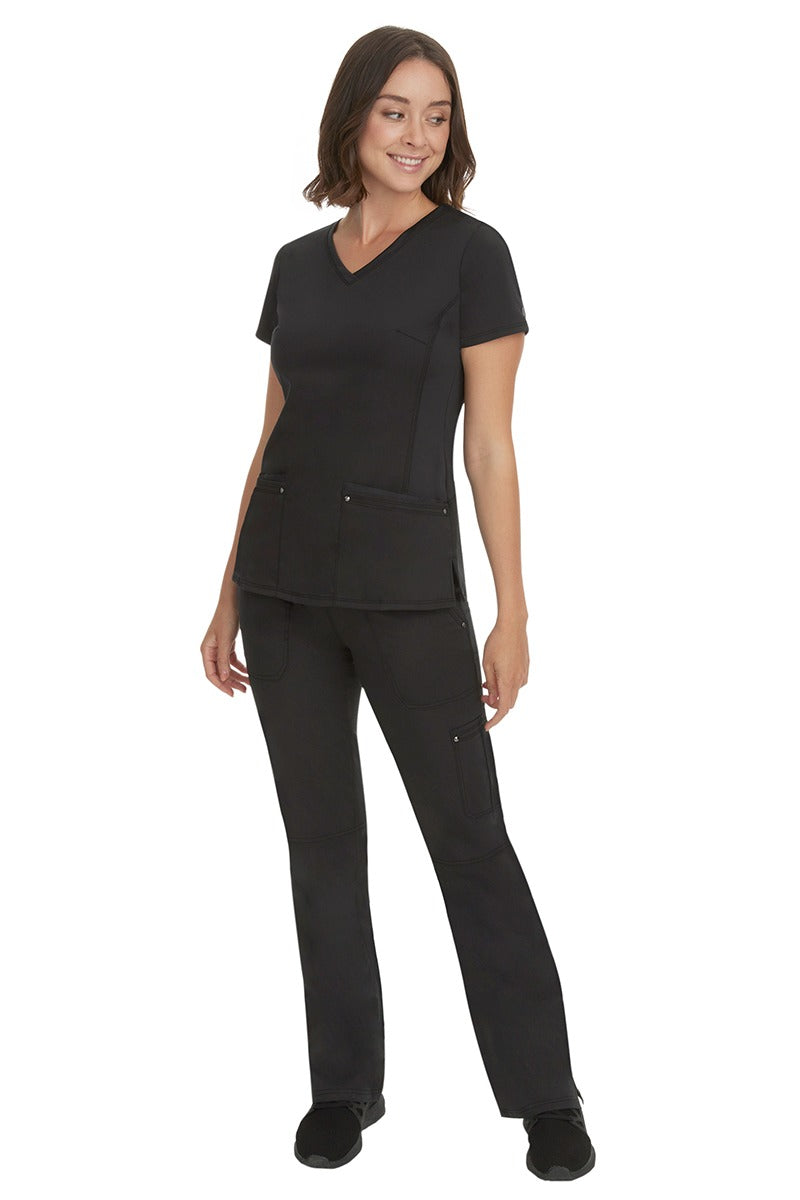 A young female nurse wearing a pair of Purple Label Women's Tori Yoga Waistband Scrub Pants from Healing Hands in Black featuring a modern fit.