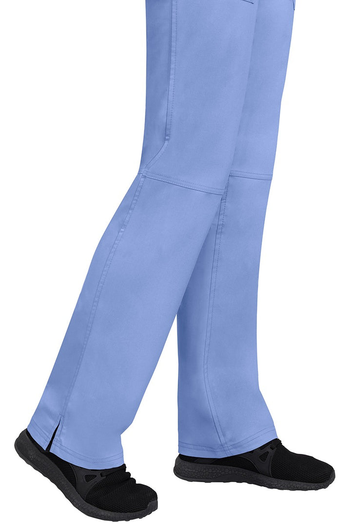 A young woman wearing a pair of Purple Label Women's Tori Yoga Waistband Scrub Pants in Ceil featuring a fabric made of 77% Polyester/ 20% Rayon/ 3% Spandex.