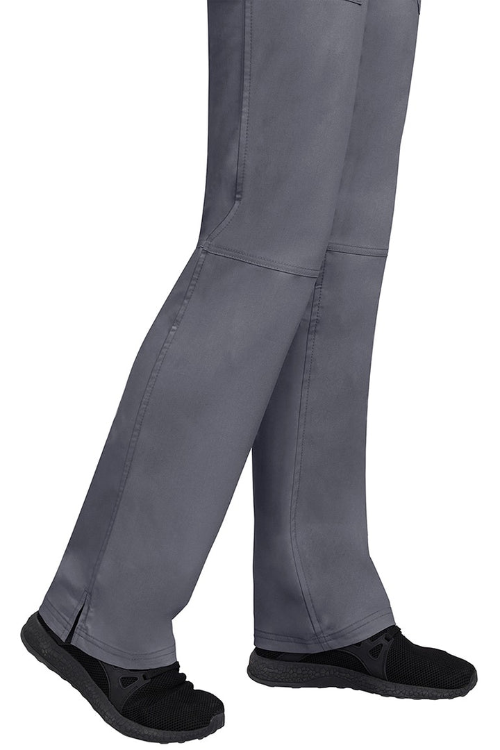 A young woman wearing a pair of Purple Label Women's Tori Yoga Waistband Scrub Pants in Pewter featuring a fabric made of 77% Polyester/ 20% Rayon/ 3% Spandex.