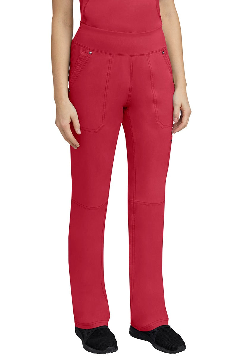A young woman wearing a Purple Label Women's Tori Yoga Waistband Scrub Pant in Red featuring a yoga knit waistband.