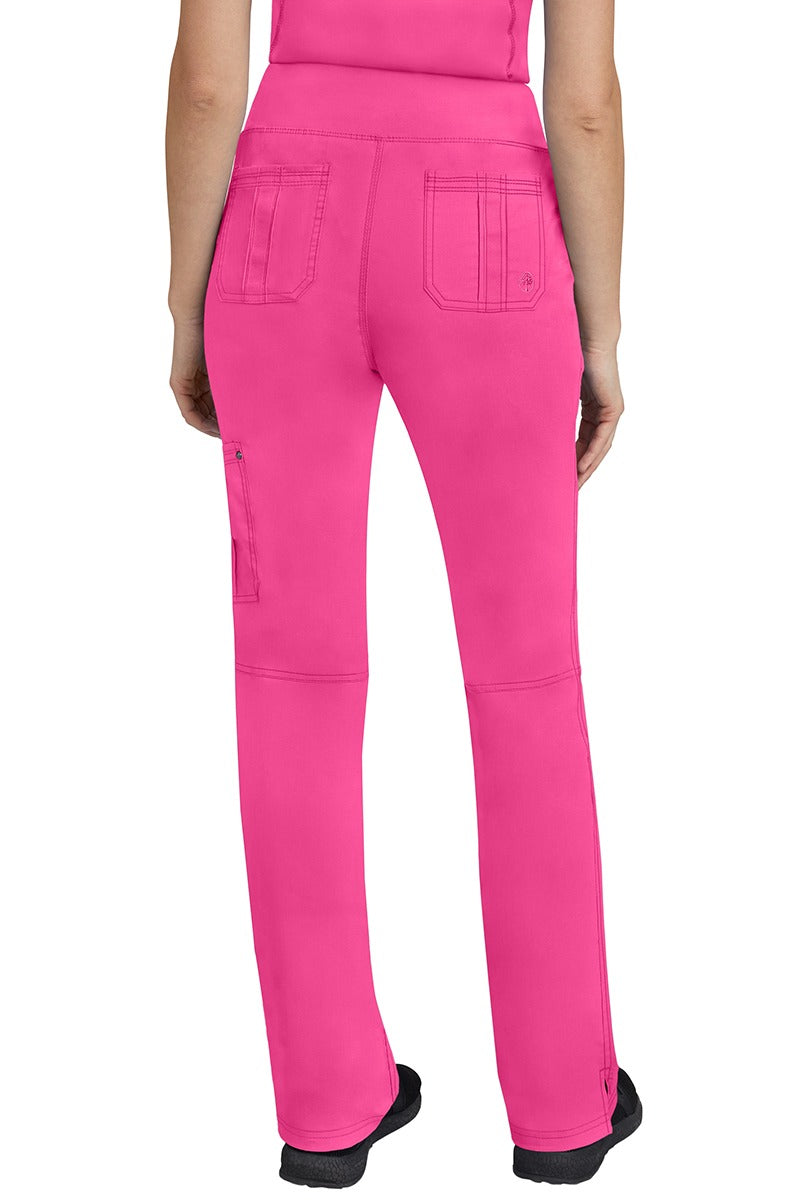 A lady CNA wearing a pair of Women's Tori Yoga Waistband Scrub Pants from Purple Label in Shocking Pink featuring 2 back patch pockets for additional on the job storage room.