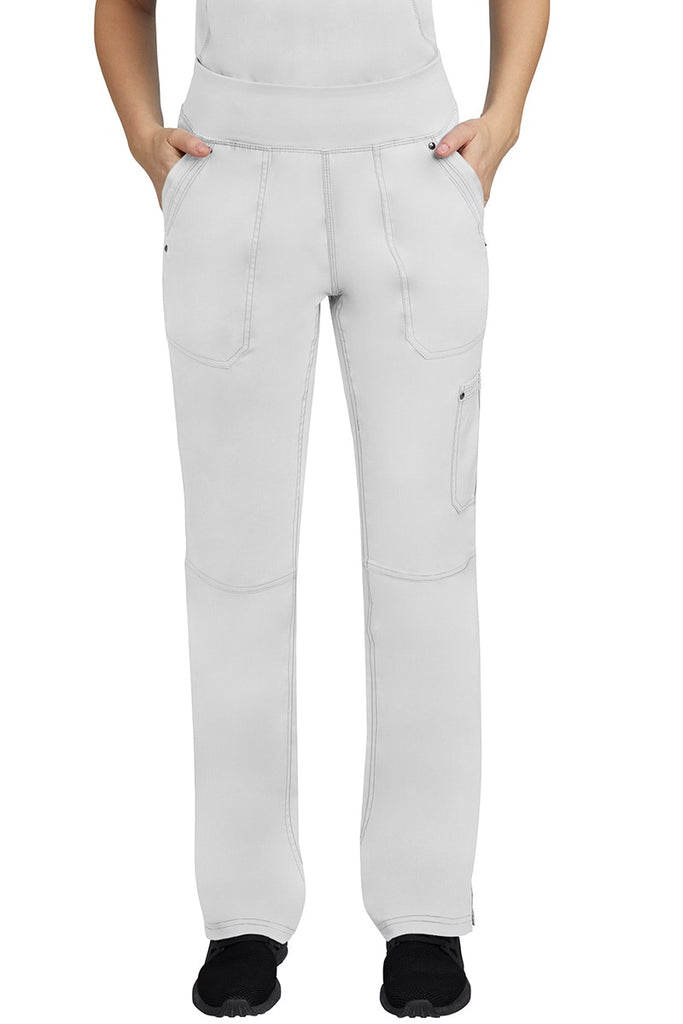 A young female LPN wearing a Purple Label Women's Tori Yoga Waistband Scrub Pant in White featuring 2 front side-entry pockets with grommet details.