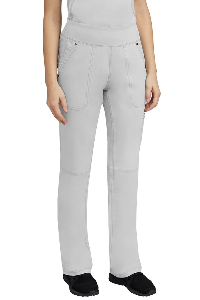 A young woman wearing a Purple Label Women's Tori Yoga Waistband Scrub Pant in White featuring a yoga knit waistband.