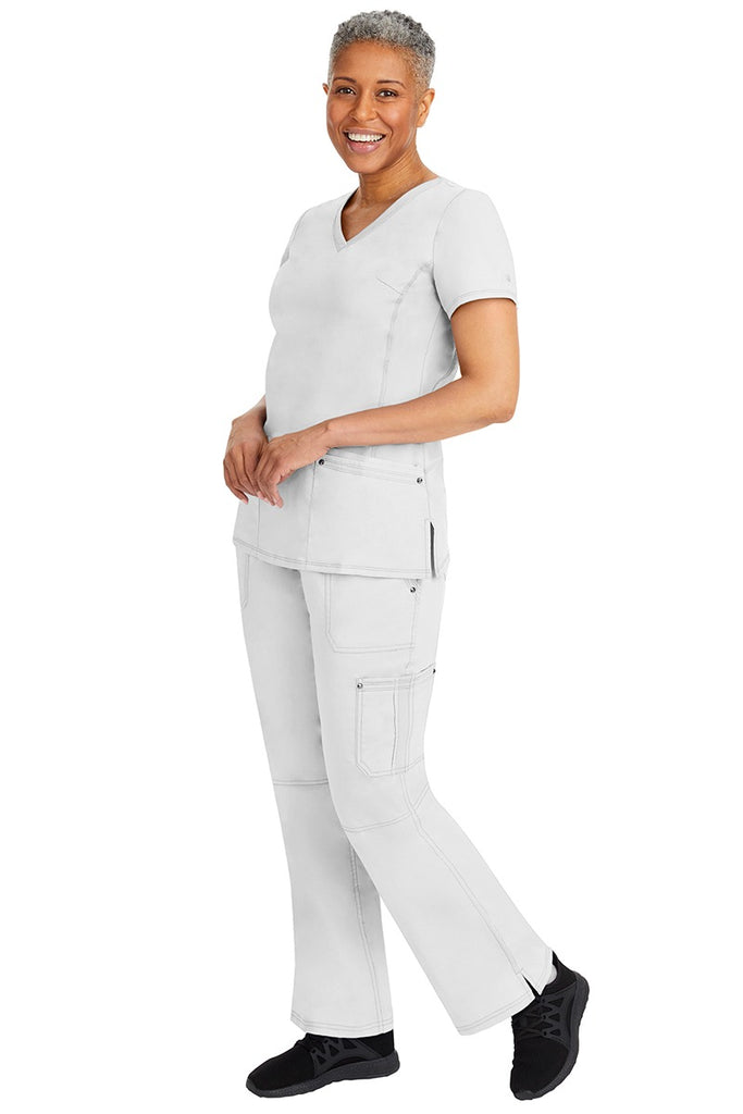A young female nurse wearing a pair of Purple Label Women's Tori Yoga Waistband Scrub Pants from Healing Hands in White featuring a modern fit.
