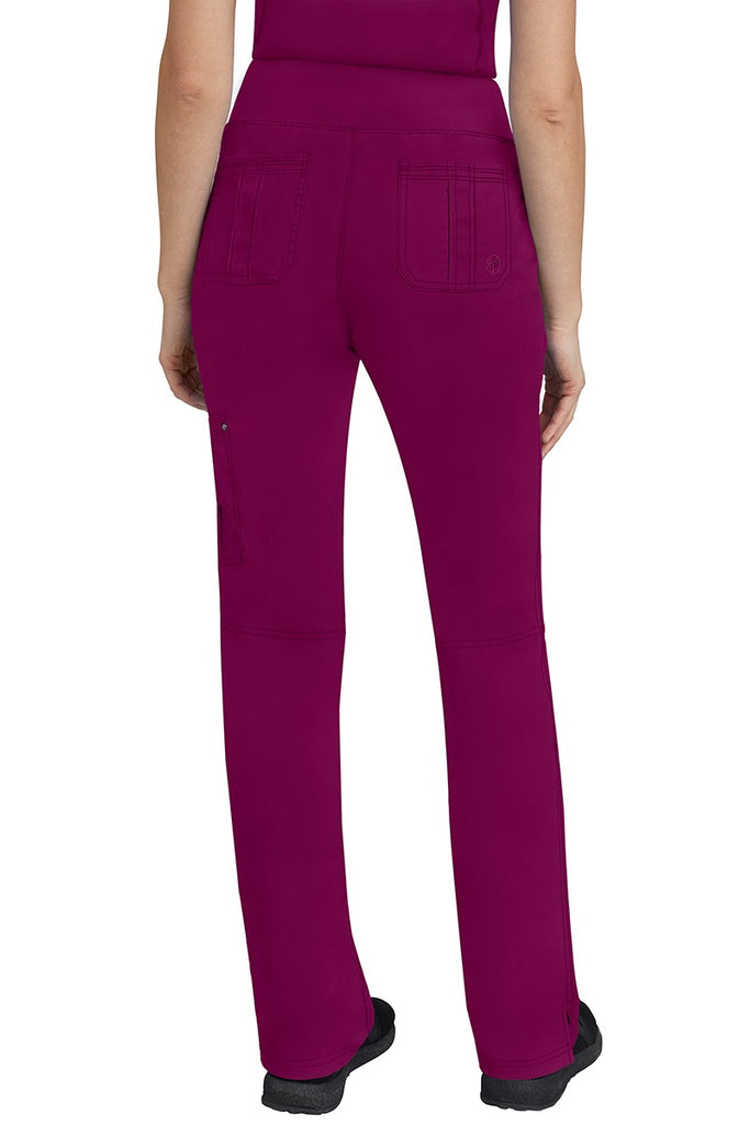 A lady CNA wearing a pair of Women's Tori Yoga Waistband Scrub Pants from Purple Label in Wine featuring 2 back patch pockets for additional on the job storage room.