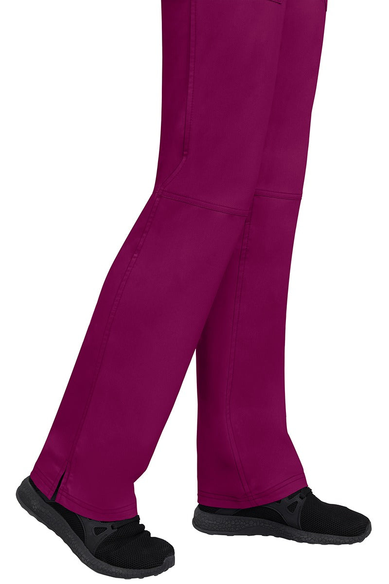 A young woman wearing a pair of Purple Label Women's Tori Yoga Waistband Scrub Pants in Wine featuring a fabric made of 77% Polyester/ 20% Rayon/ 3% Spandex.