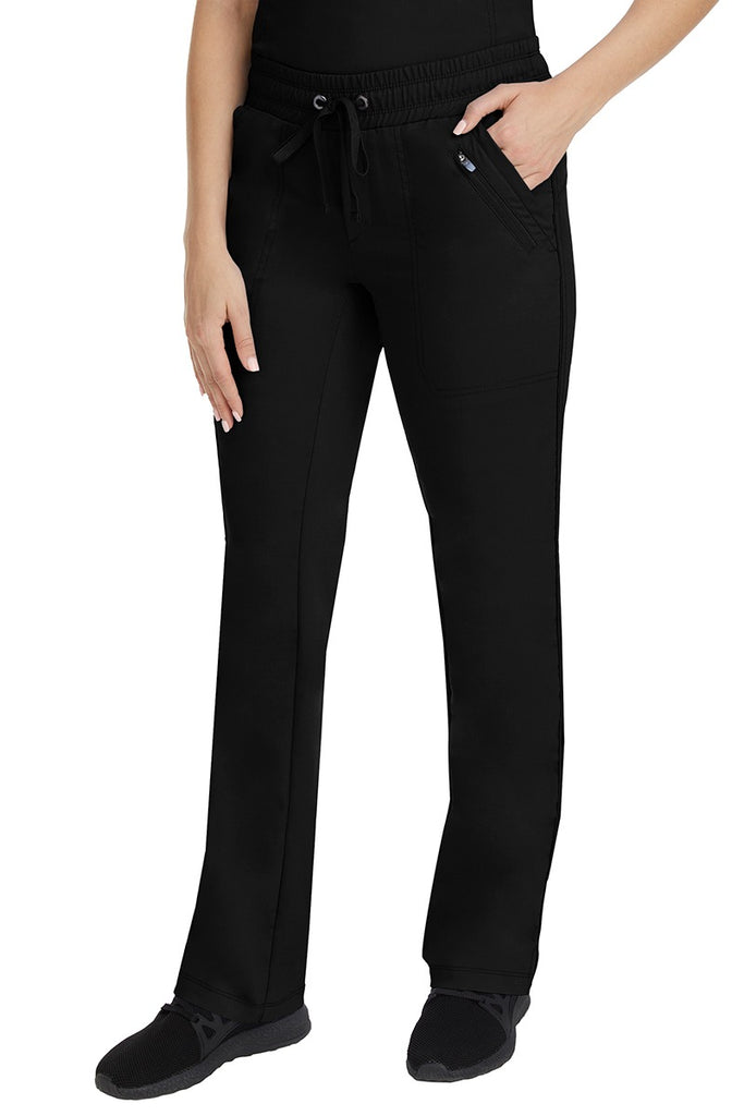 A young Home Care Registered Nurse wearing a pair of Purple Label Women's Tanya Drawstring Cargo Scrub Pant in Black featuring 2 front slash pockets.