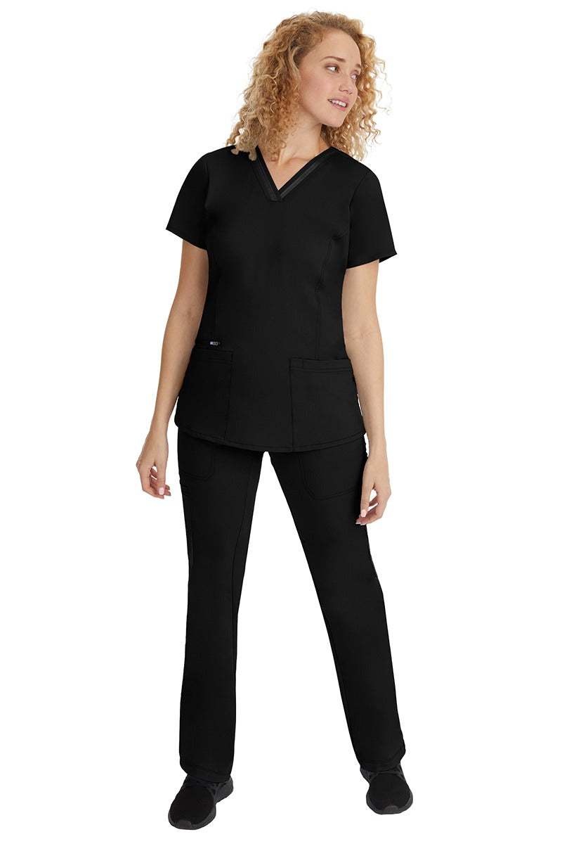 A young woman wearing a pair of Purple Label Women's Tanya Drawstring Cargo Scrub Pant from Healing Hands in Black size small.