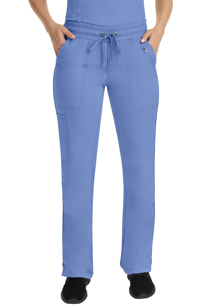 A young female Nurse Practitioner wearing a Purple Label Women's Tanya Drawstring Cargo Scrub Pant in Ceil featuring a fully elasticized comfort stretch waistband.