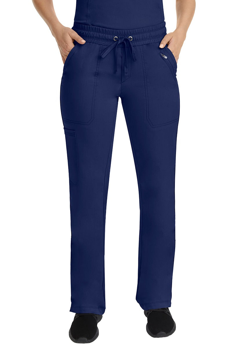 A young female Nurse Practitioner wearing a Purple Label Women's Tanya Drawstring Cargo Scrub Pant in Navy featuring a fully elasticized comfort stretch waistband.
