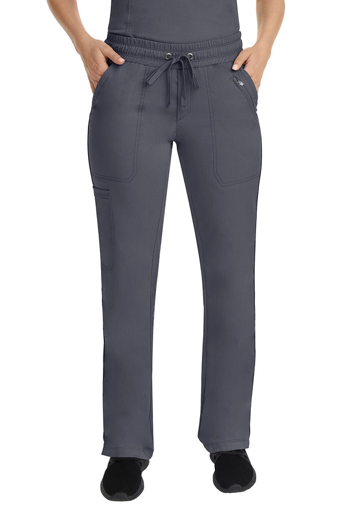 A young female Nurse Practitioner wearing a Purple Label Women's Tanya Drawstring Cargo Scrub Pant in Pewter featuring a fully elasticized comfort stretch waistband.