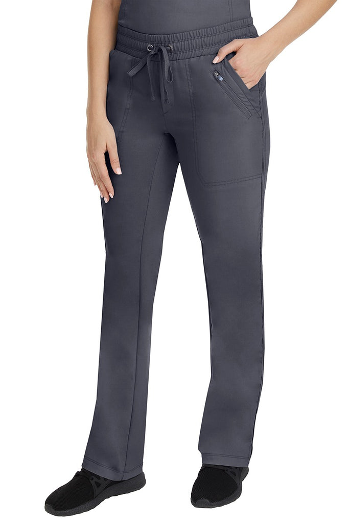 A young Home Care Registered Nurse wearing a pair of Purple Label Women's Tanya Drawstring Cargo Scrub Pant in Pewter featuring 2 front slash pockets.