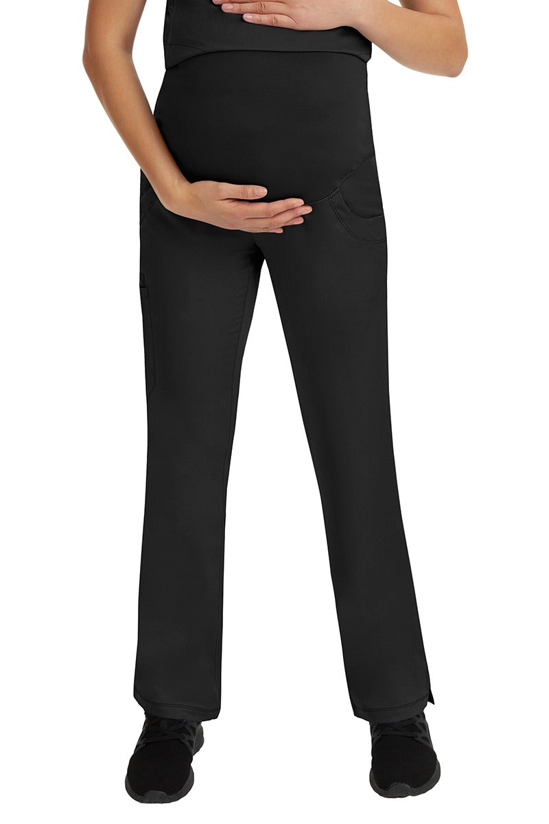 A young female LPN wearing an HH-Works Women's Rose Maternity Cargo Scrub Pant in Black featuring a stretch yoga waistband.
