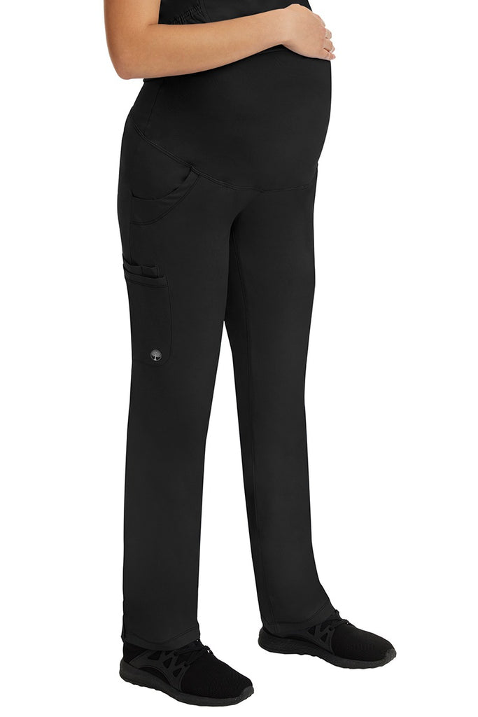 A woman LVN wearing a HH-Works Women's Rose Maternity Cargo Scrub Pant in Black featuring a fade resistant fabric to provide a long lasting fresh fit.