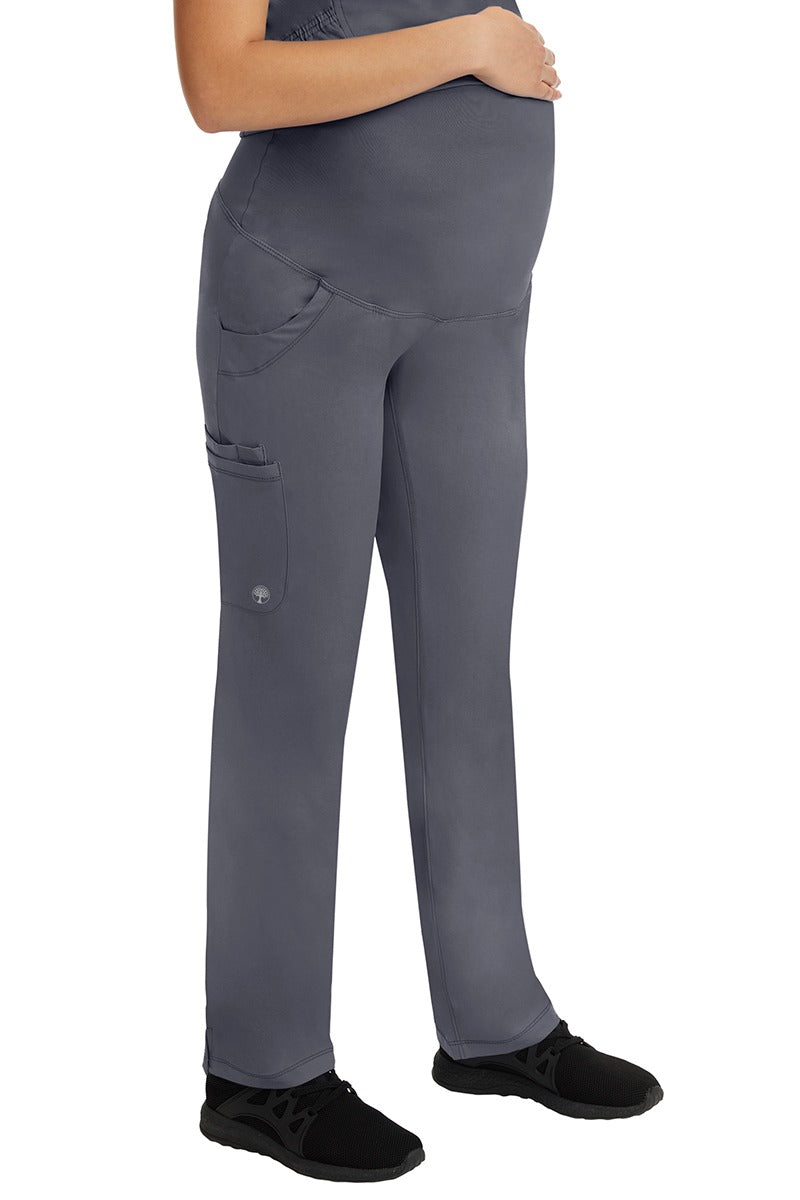 A woman LVN wearing a HH-Works Women's Rose Maternity Cargo Scrub Pant in Pewter  featuring a fade resistant fabric to provide a long lasting fresh fit.