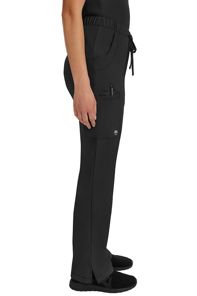 A young woman wearing an HH-Works Women's Rebecca Multi-Pocket Drawstring Pant  in Black featuring a super comfortable stretch fabric made of 91% polyester & 9% spandex.