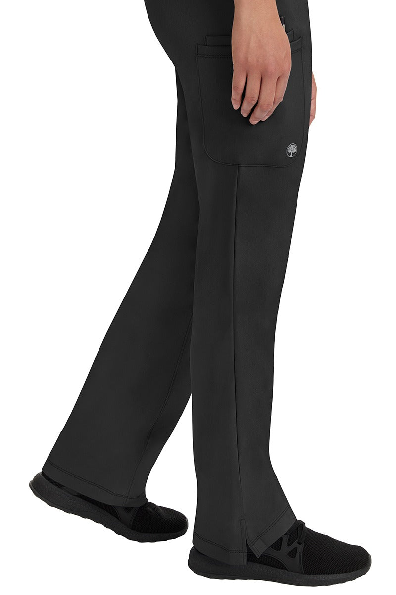 A young woman wearing an HH-Works Women's Rebecca Multi-Pocket Drawstring Pant in Black. Perfect for Healthcare Professionals working in Hospitals or as Physical Therapists, Optometrists, & Chiropractors!