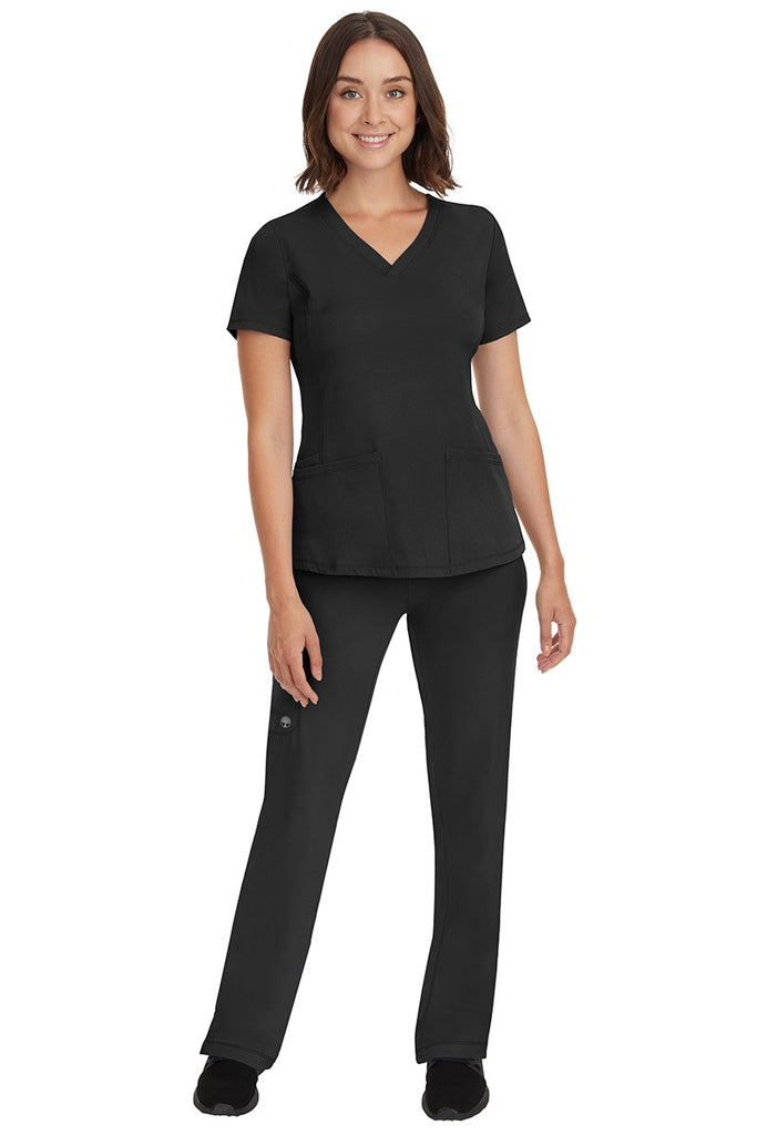 A young female nurse wearing a Women's Rebecca Multi-Pocket Drawstring Pant from HH Works in Black featuring a quick-dry, moisture wicking fabric that is fade resistant.