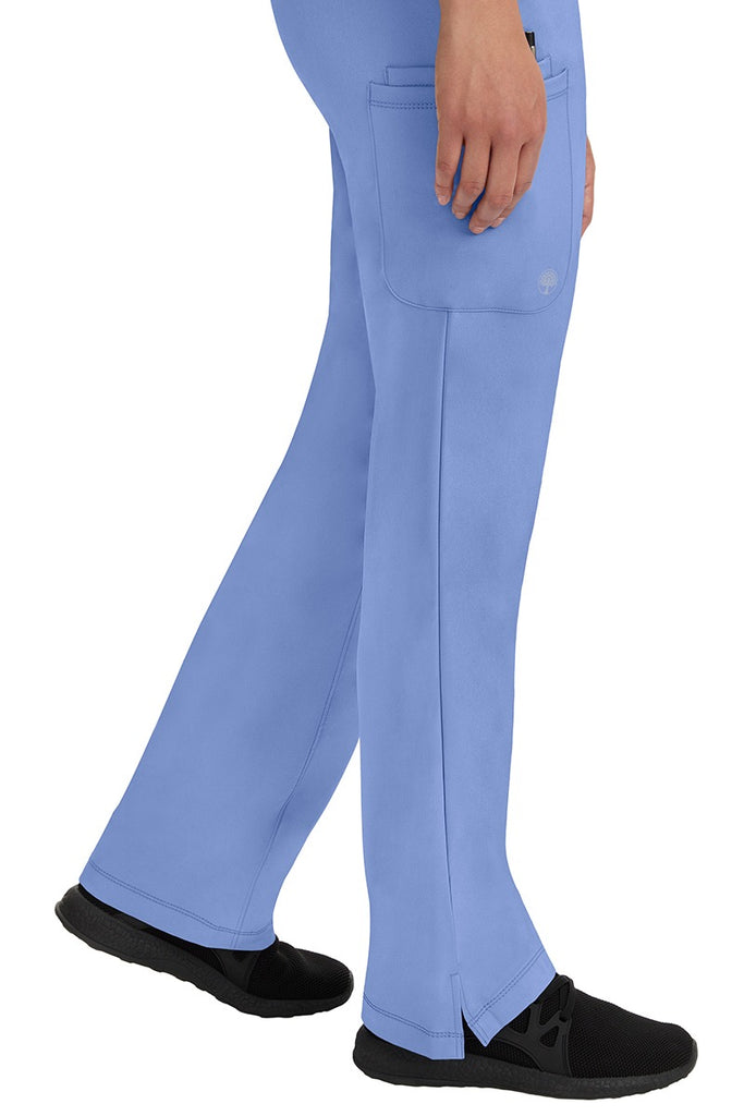 A young woman wearing an HH-Works Women's Rebecca Multi-Pocket Drawstring Pant in Ceil. Perfect for Healthcare Professionals working in Hospitals or as Physical Therapists, Optometrists, & Chiropractors!