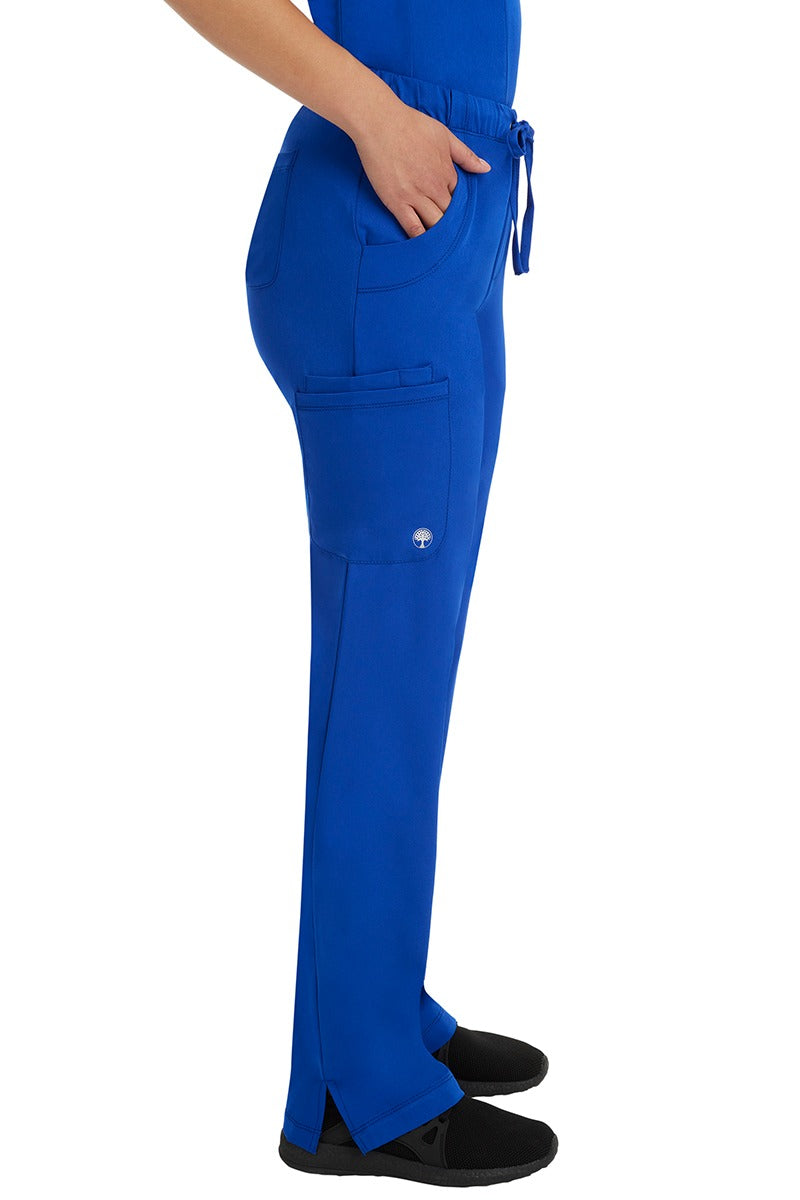 A young woman wearing an HH-Works Women's Rebecca Multi-Pocket Drawstring Pant in Galaxy Blue featuring a super comfortable stretch fabric made of 91% polyester & 9% spandex.