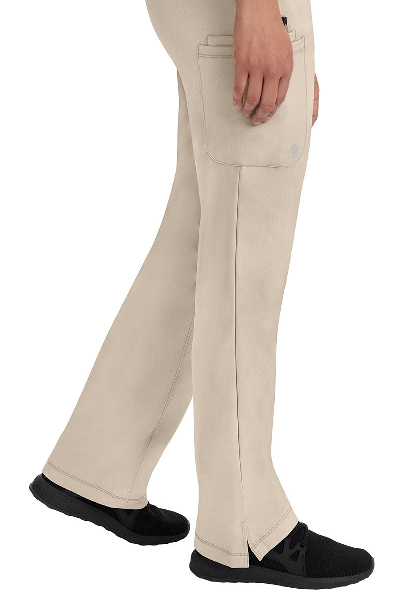 A young woman wearing an HH-Works Women's Rebecca Multi-Pocket Drawstring Pant Khaki. Perfect for Healthcare Professionals working in Hospitals or as Physical Therapists, Optometrists, & Chiropractors!