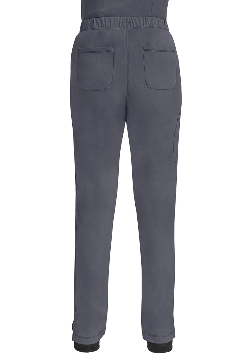 A lady CNA wearing an HH-Works Women's Rebecca Multi-Pocket Drawstring Pant in Pewter featuring 2 back patch pockets for any additional on the job storage needs.