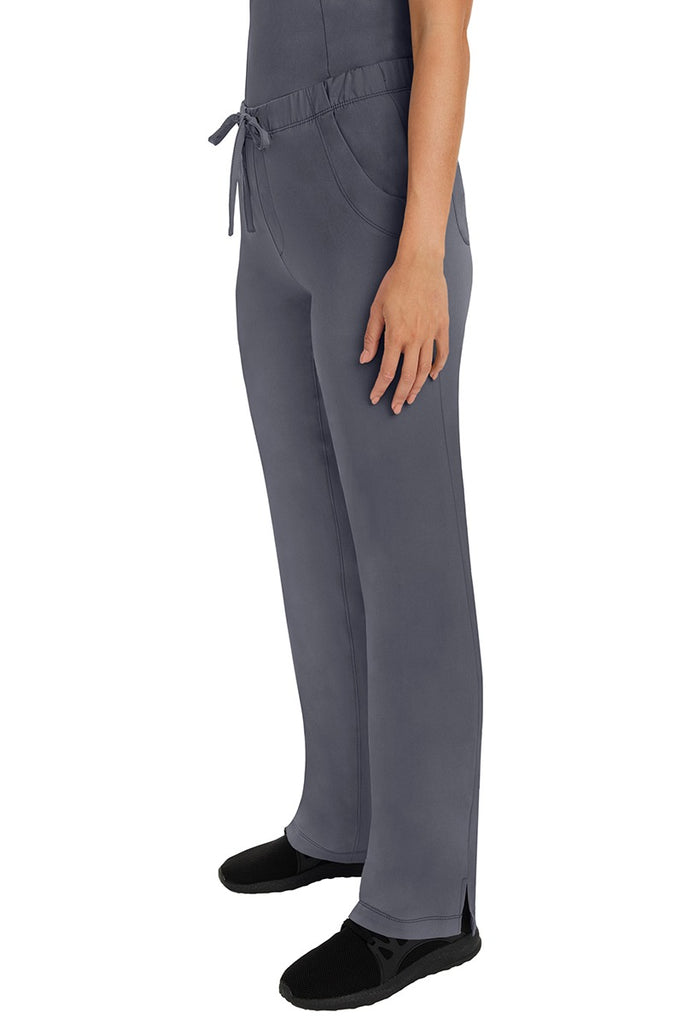 A woman Home Care Registered Nurse wearing a pair of HH-Works Women's Rebecca Multi-Pocket Drawstring Pants in Pewter featuring side slits for additional range of motion.