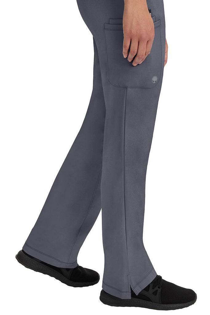 A young woman wearing an HH-Works Women's Rebecca Multi-Pocket Drawstring Pant in Pewter. Perfect for Healthcare Professionals working in Hospitals or as Physical Therapists, Optometrists, & Chiropractors!