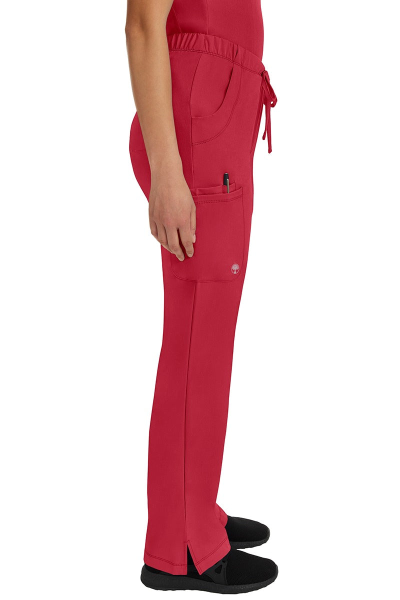 A young female Cardiovascular Nurse wearing a pair of HH Works Women's Rebecca Multi-Pocket Drawstring Scrub Pantys in Red size Medium featuring ankle vents for additional easy removal.