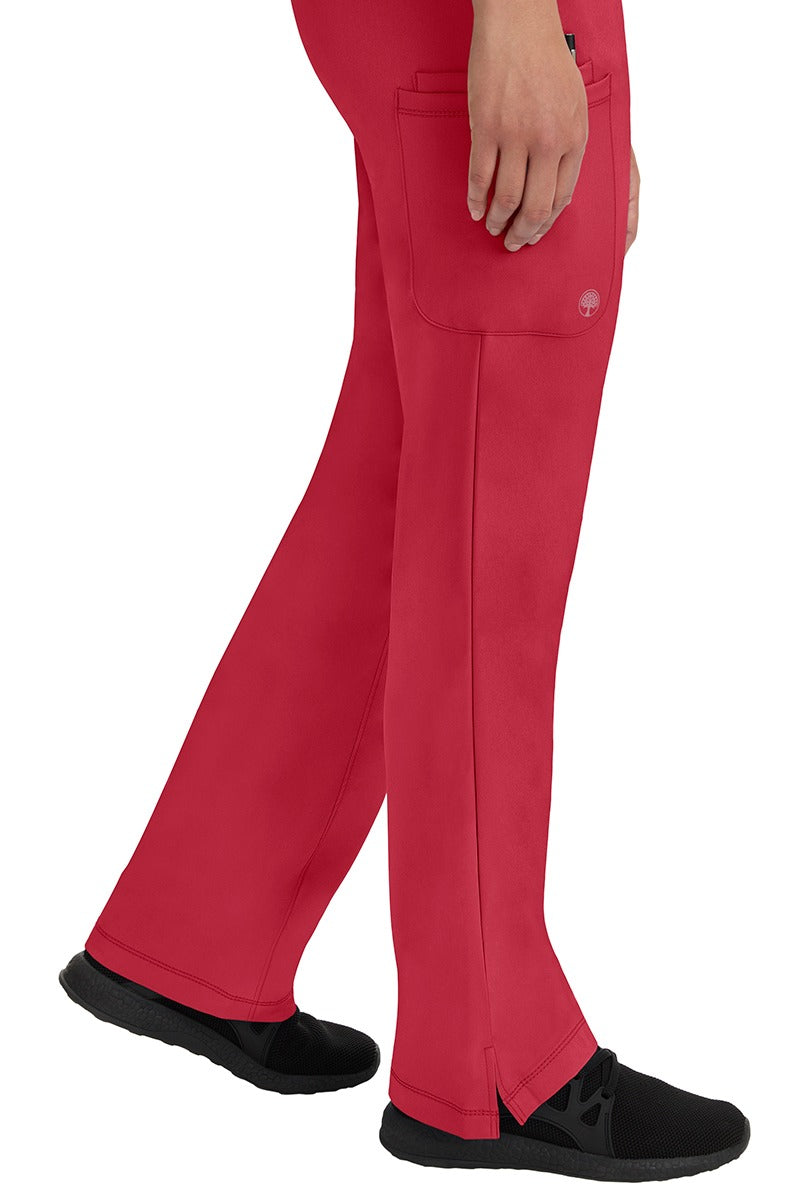 A young woman wearing an HH-Works Women's Rebecca Multi-Pocket Drawstring Pant in Red. Perfect for Healthcare Professionals working in Hospitals or as Physical Therapists, Optometrists, & Chiropractors!