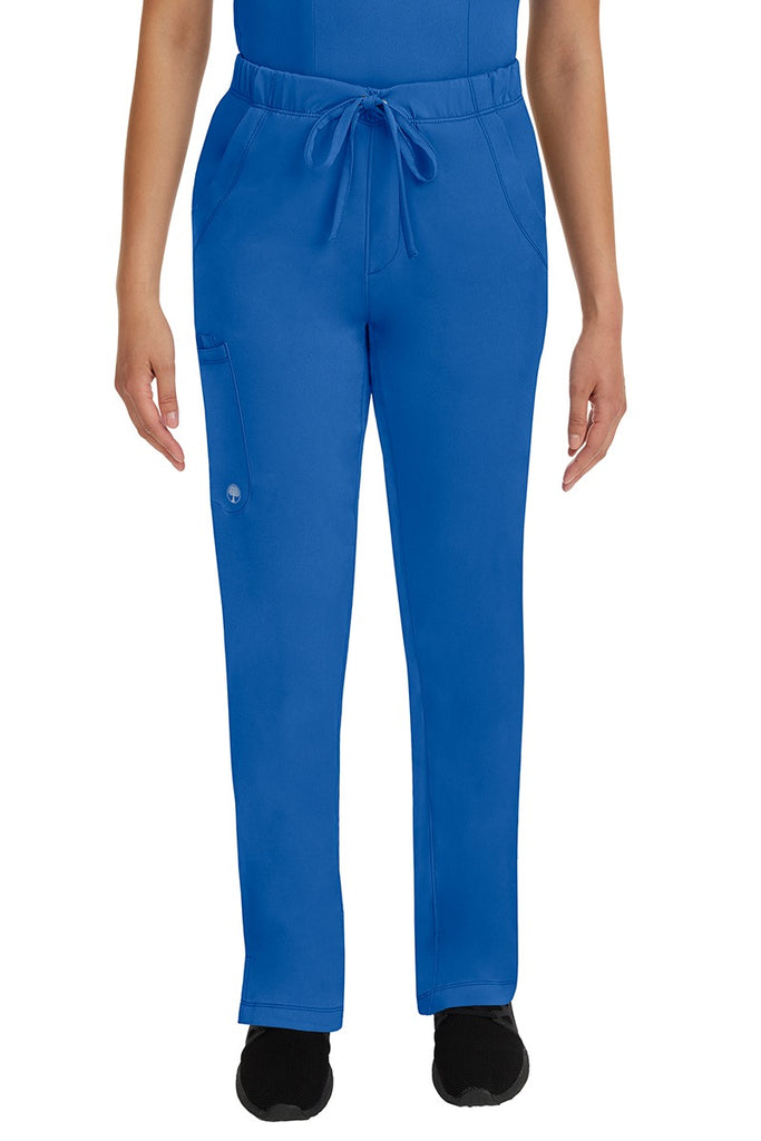 A young lady LPN wearing an HH Works Women's Rebecca Multi-Pocket Drawstring Pant in Royal featuring n all elastic waistband with a drawstring tie front.