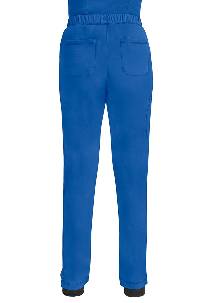 A lady CNA wearing an HH-Works Women's Rebecca Multi-Pocket Drawstring Pant in Royal featuring 2 back patch pockets for any additional on the job storage needs.