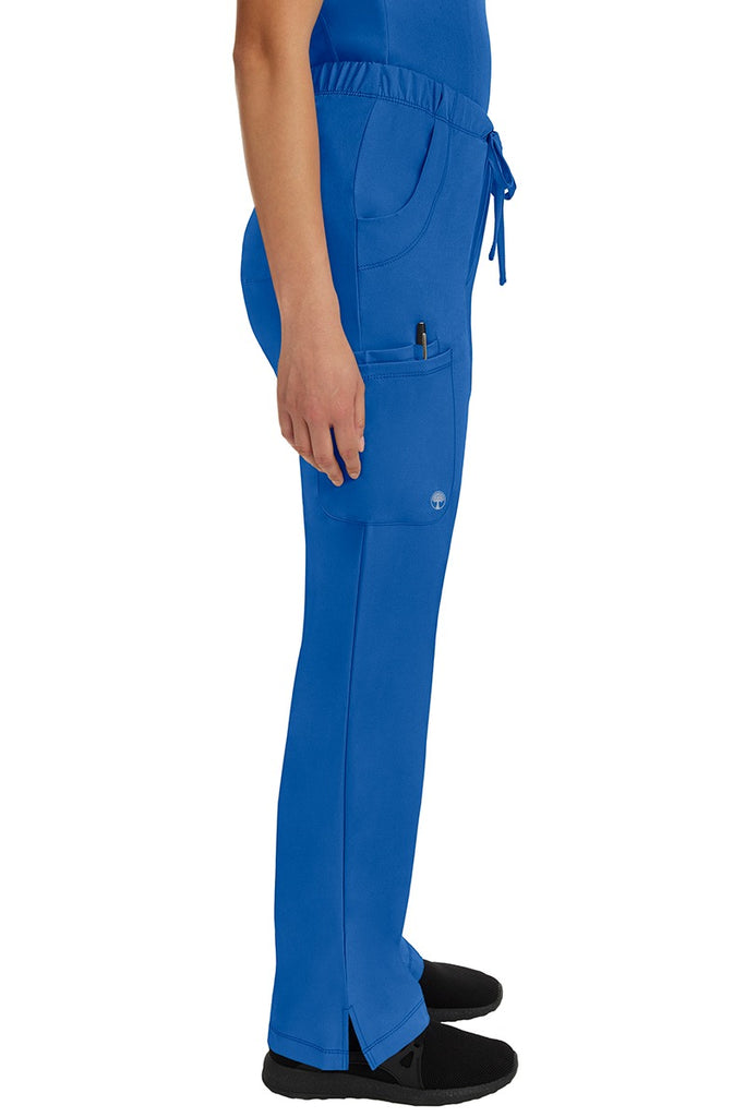 A young woman wearing an HH-Works Women's Rebecca Multi-Pocket Drawstring Pant in Royal featuring a super comfortable stretch fabric made of 91% polyester & 9% spandex.