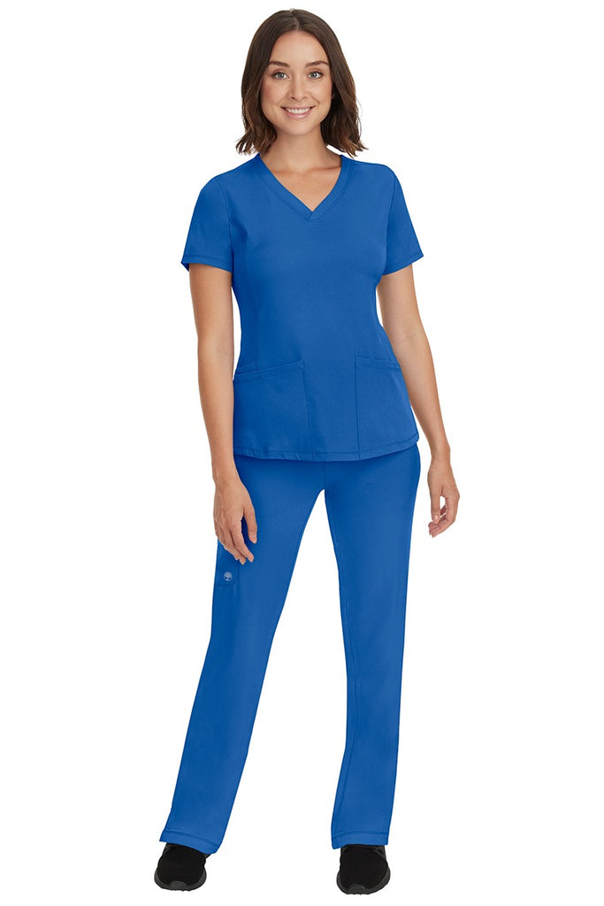 A young female nurse wearing a Women's Rebecca Multi-Pocket Drawstring Pant from HH Works in Royal featuring a quick-dry, moisture wicking fabric that is fade resistant.