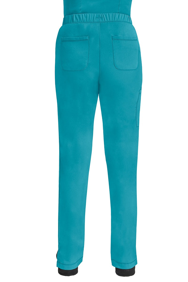 A lady CNA wearing an HH-Works Women's Rebecca Multi-Pocket Drawstring Pant in Teal featuring 2 back patch pockets for any additional on the job storage needs.