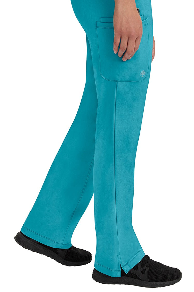A young woman wearing an HH-Works Women's Rebecca Multi-Pocket Drawstring Pant in Teal. Perfect for Healthcare Professionals working in Hospitals or as Physical Therapists, Optometrists, & Chiropractors!