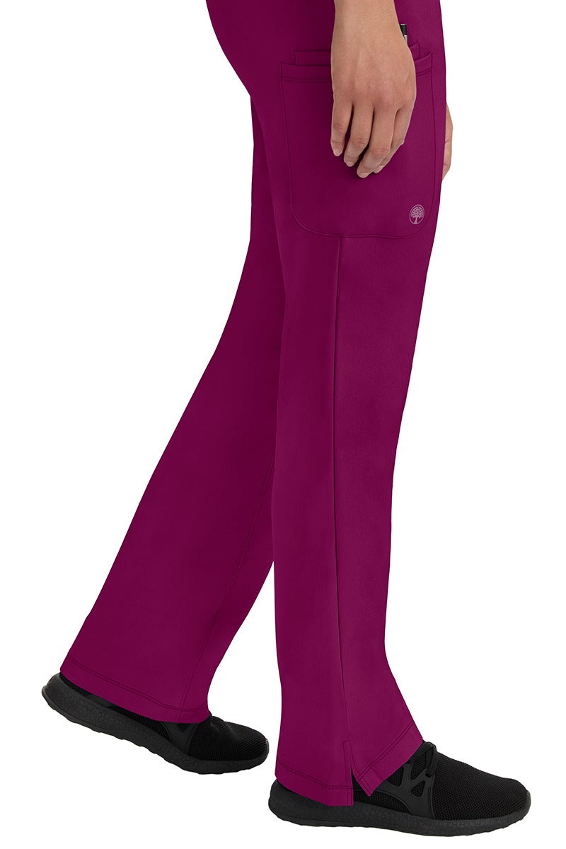 A young woman wearing an HH-Works Women's Rebecca Multi-Pocket Drawstring Pant in Wine. Perfect for Healthcare Professionals working in Hospitals or as Physical Therapists, Optometrists, & Chiropractors!