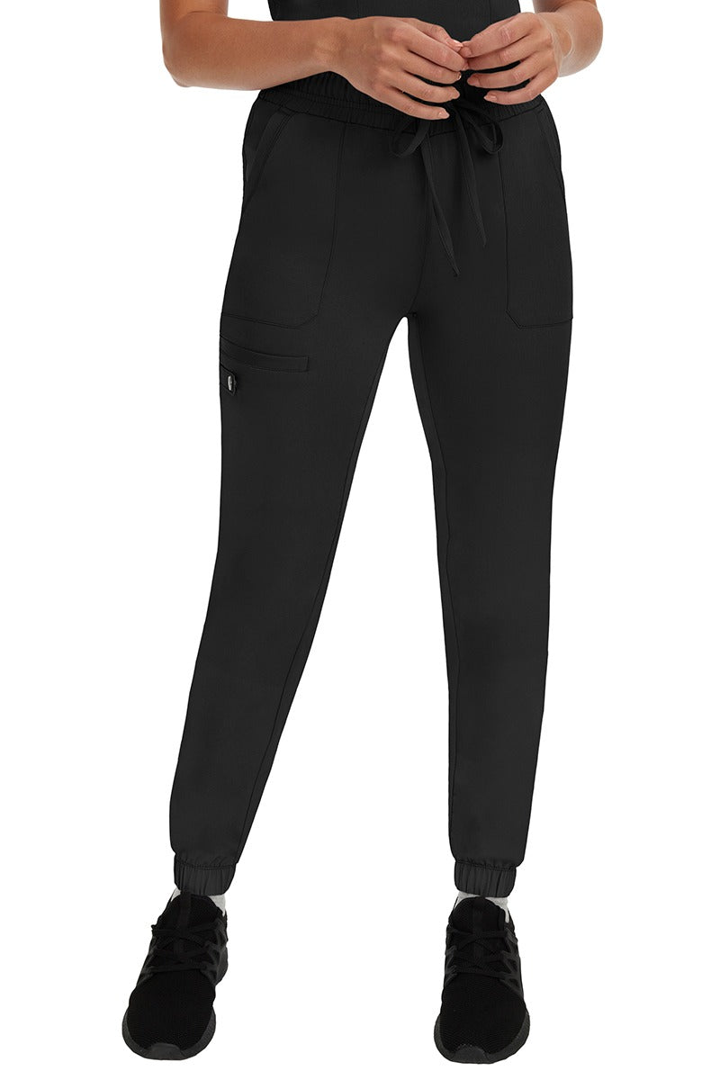 A young woman LVN wearing a pair of the HH Works Women's Renee Jogger Scrub Pants in Black featuring a super comfortable, easy care fabric. 