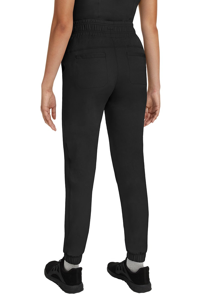 A young Home Care Registered Nurse wearing a Women's Renee Jogger Scrub Pant from HH Works in Black featuring 2 back patch pockets for additional storage room.