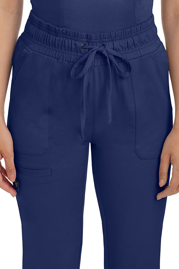 A female nurse wearing a Women's Renee Jogger Scrub Pant from HH Works in Navy featuring a drawstring tie front.