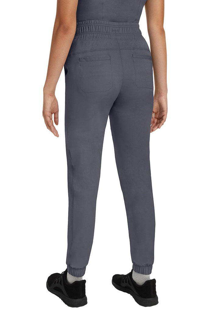 A young Home Care Registered Nurse wearing a Women's Renee Jogger Scrub Pant from HH Works in Pewter featuring 2 back patch pockets for additional storage room.