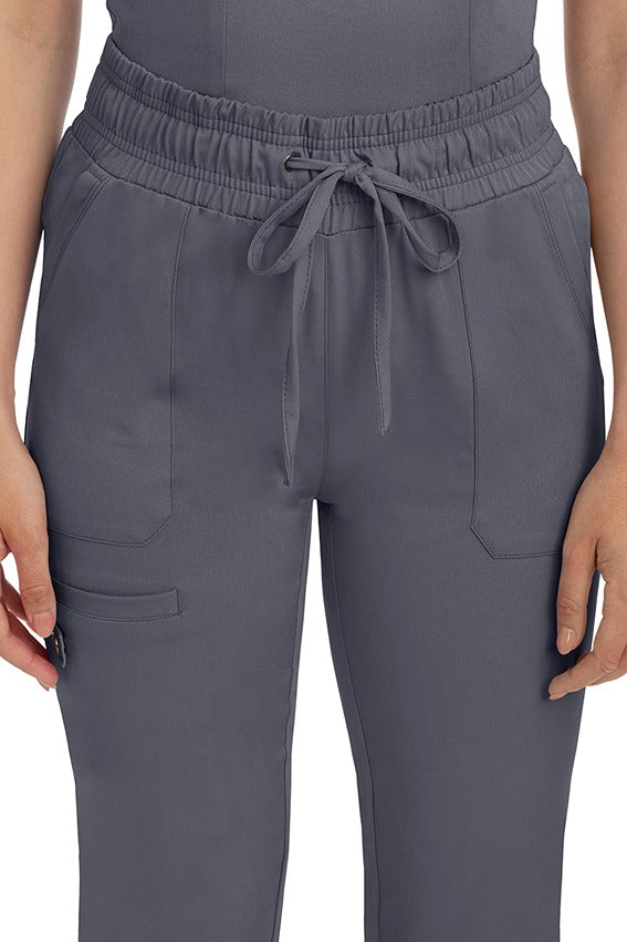 A female nurse wearing a Women's Renee Jogger Scrub Pant from HH Works in Pewter featuring a drawstring tie front.