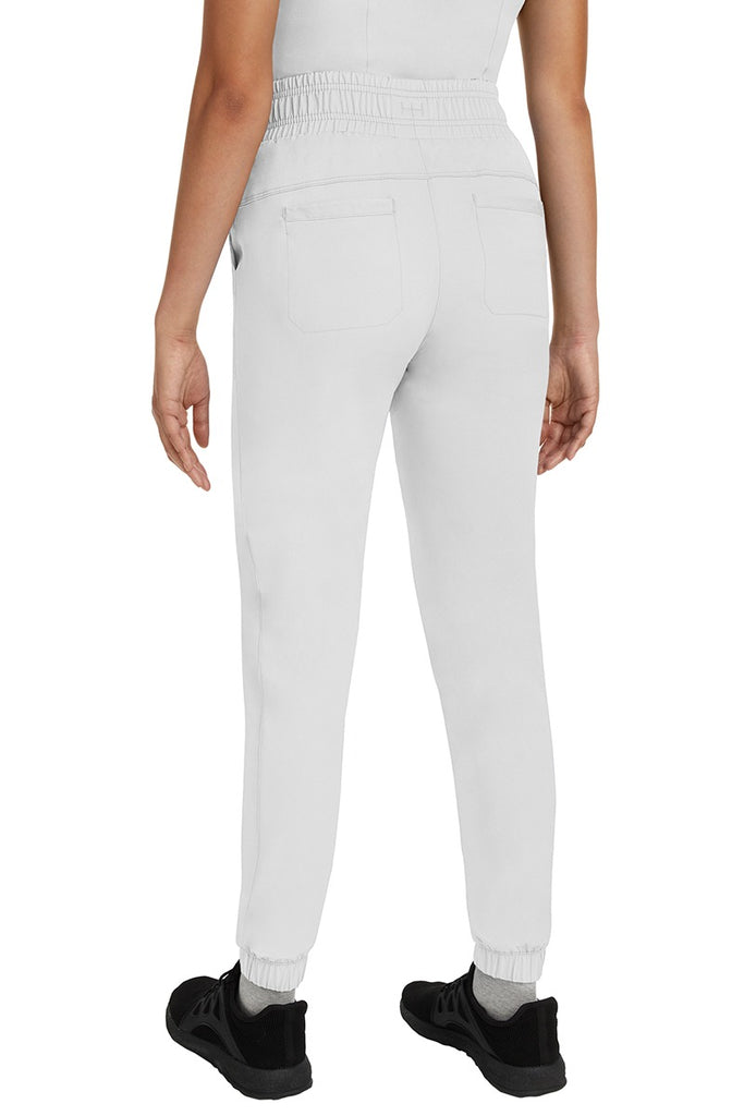 A young Home Care Registered Nurse wearing a Women's Renee Jogger Scrub Pant from HH Works in White featuring 2 back patch pockets for additional storage room.