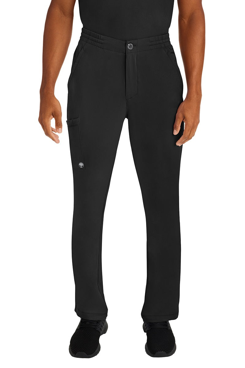 A male LPN wearing a Men's Ryan Multi-Pocket Cargo Scrub Pant from HH Works in Black size large. featuring a functional zipper front with button closure.