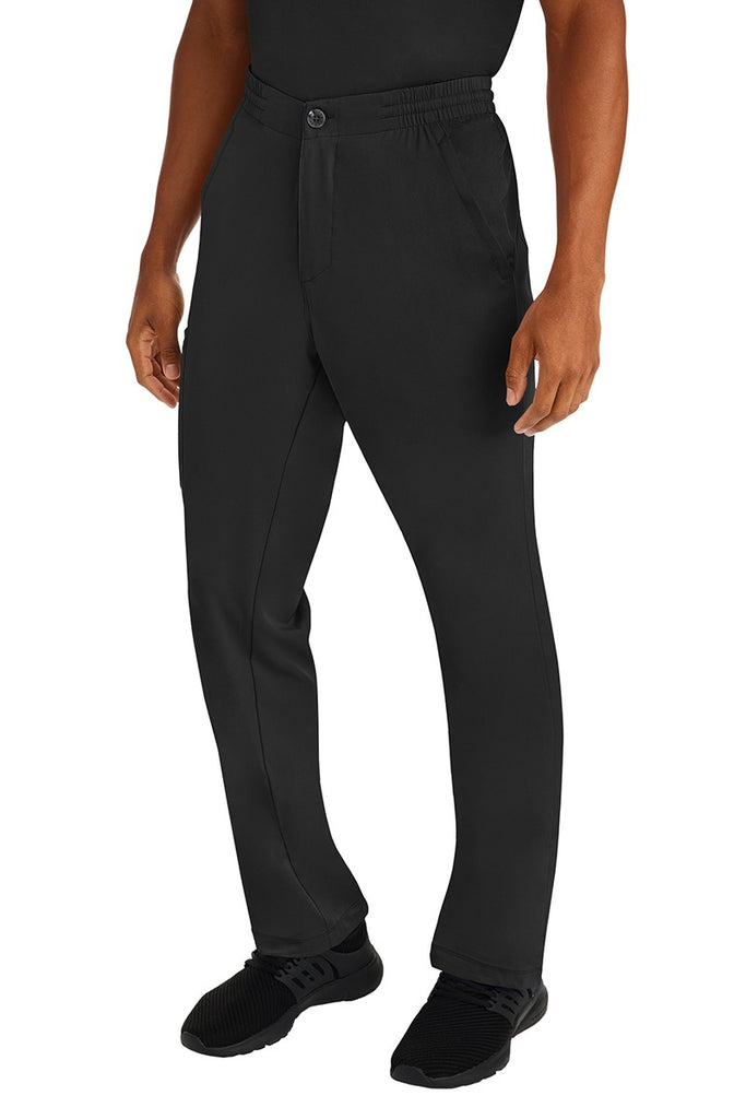 A male clinical nurse specialist wearing an HH-Works Men's Ryan Multi-Pocket Cargo Scrub Pant in Black featuring a hidden drawstring & elastic waistband.