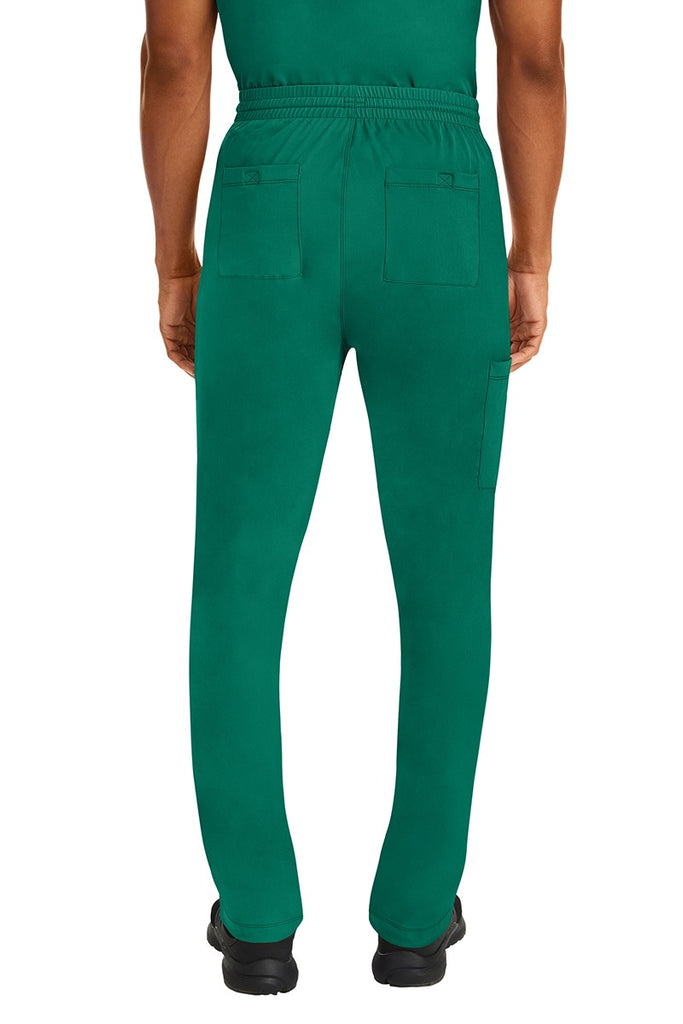A male Nurse Practitioner wearing an HH-Works Men's Ryan Multi-Pocket Cargo Scrub Pant in Hunter Green featuring two back patch pockets.