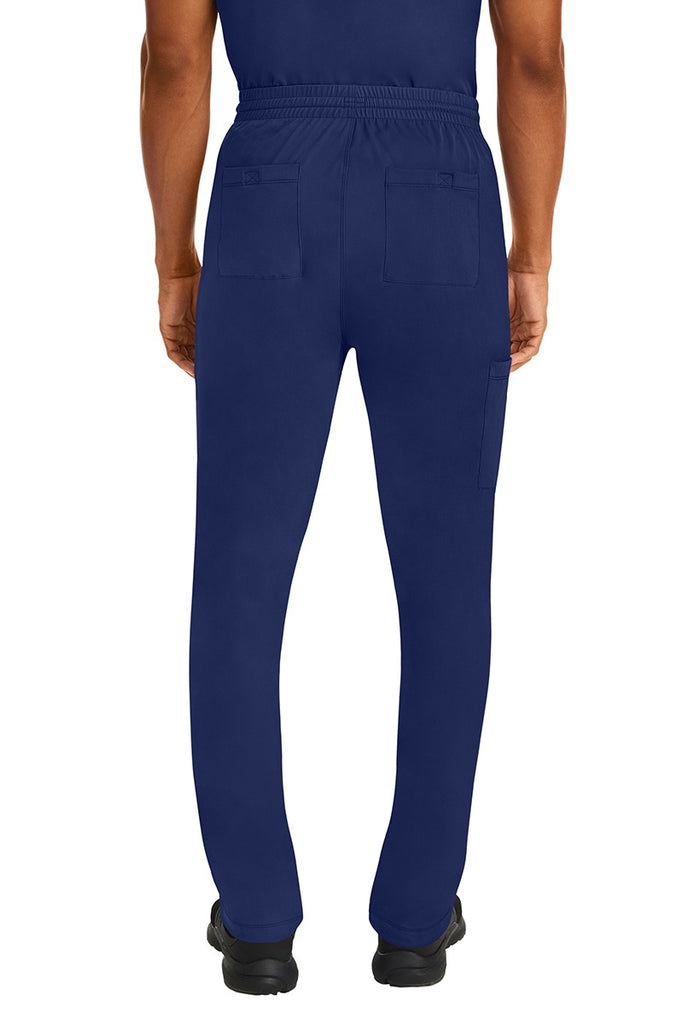 A male Nurse Practitioner wearing an HH-Works Men's Ryan Multi-Pocket Cargo Scrub Pant in Navy featuring two back patch pockets.