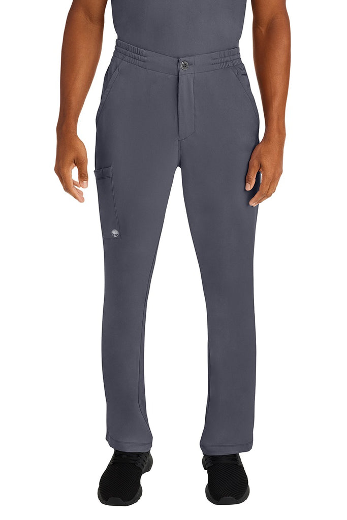 A male LPN wearing a Men's Ryan Multi-Pocket Cargo Scrub Pant from HH Works in Pewter size large. featuring a functional zipper front with button closure.