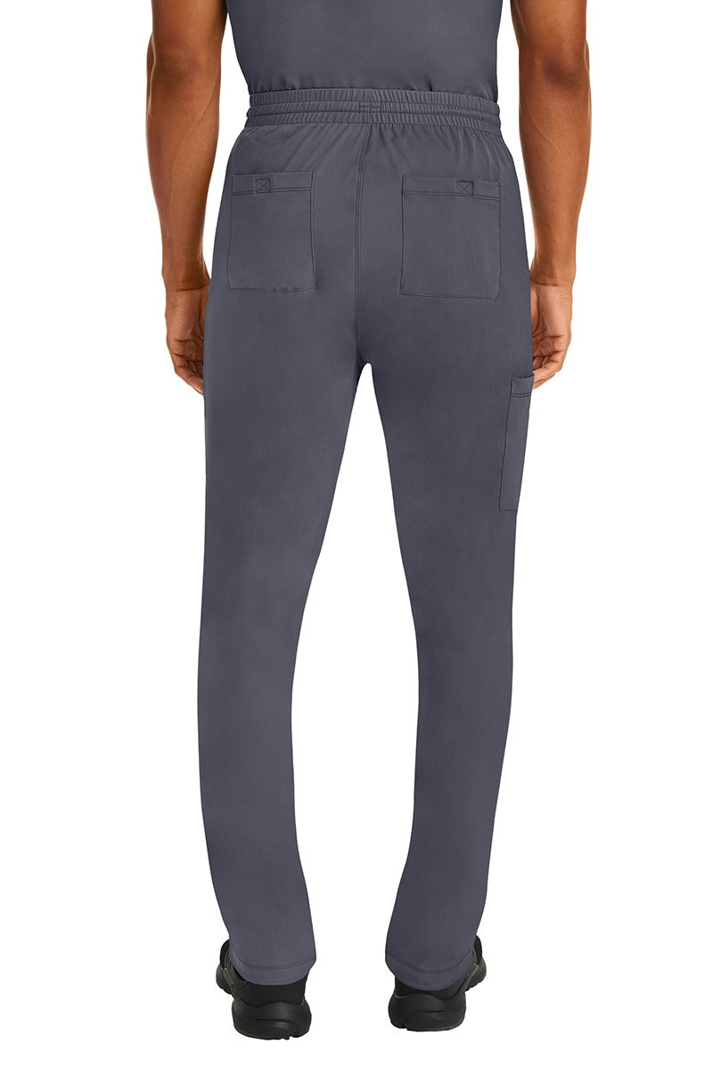 A male Nurse Practitioner wearing an HH-Works Men's Ryan Multi-Pocket Cargo Scrub Pant in Pewter featuring two back patch pockets.